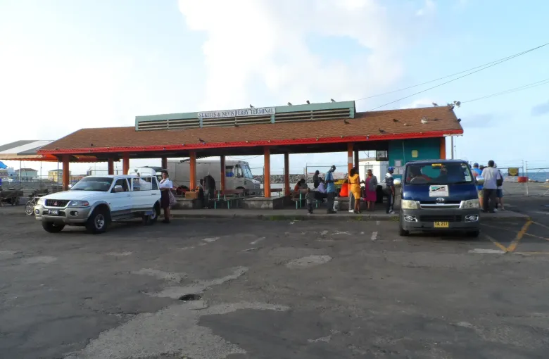 The open sheltered forecourt of the St Kitts and Nevis ferry terminal, with a level paved approach.