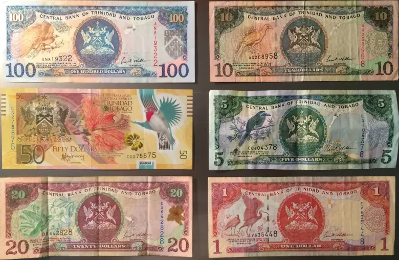 Trinidad and Tobago dollar banknotes from one to one hundred dollars, each carrying a national bird.