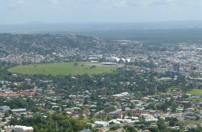 Port of Spain seen from the hills, the green oval of the Queen's Park Savannah at its center.
