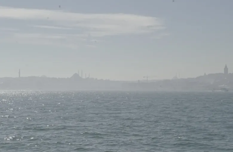 The Bosphorus at Istanbul, Turkey, on a hazy day, the domes and minarets of the old city faint on the far shore.