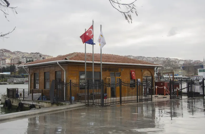 The timber ferry pier at Eyupsultan on the Golden Horn in Istanbul, Turkey, its level boarding deck wet after rain.