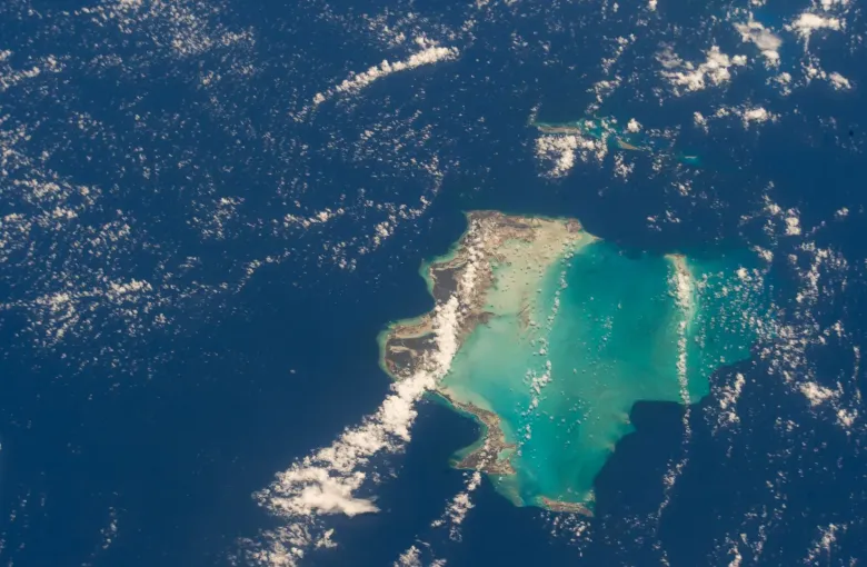 The Turks and Caicos Islands photographed from the International Space Station, low land ringed by pale shallows.