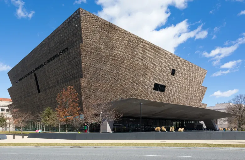 The bronze filigree corona of the museum rising in three tiers above its entrance canopy on the National Mall.