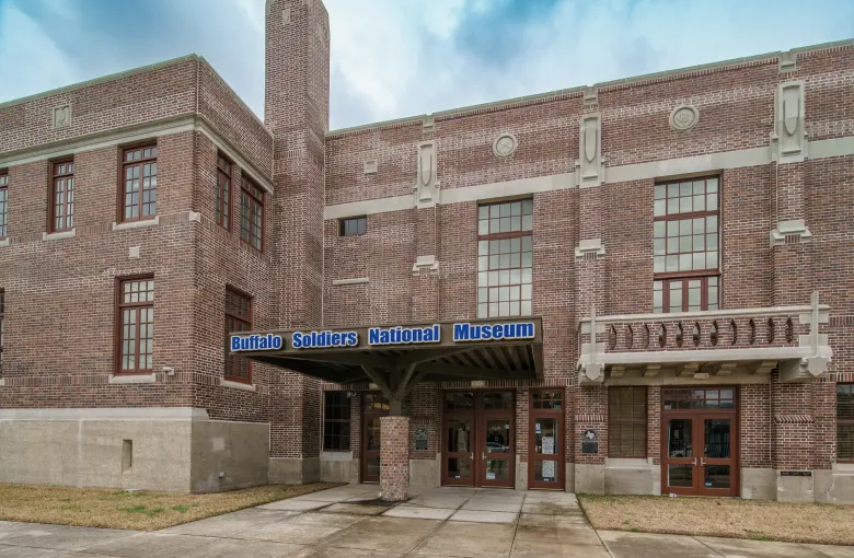 The brick entrance of the Buffalo Soldiers National Museum in Houston with its name on the canopy.