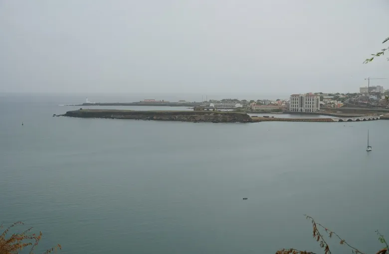 The Plateau headland and lighthouse above Praia bay on Santiago, seen in harmattan haze.