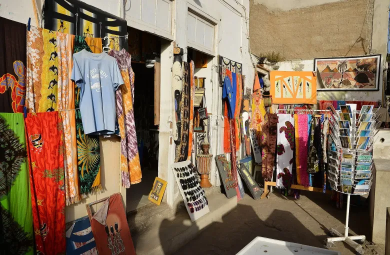 Pareos, printed shirts, carved masks and postcards hung outside a souvenir shop on Sal.