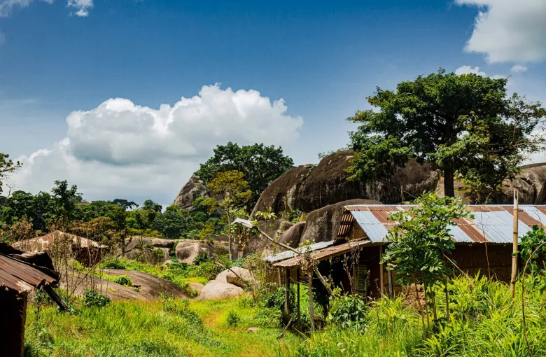 Granite domes and boulders rising above trees and tin-roofed buildings at Idanre in Ondo State, Nigeria.